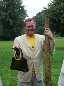 Robin Hellier holding Madam Mayor's handbag while she planted a tree